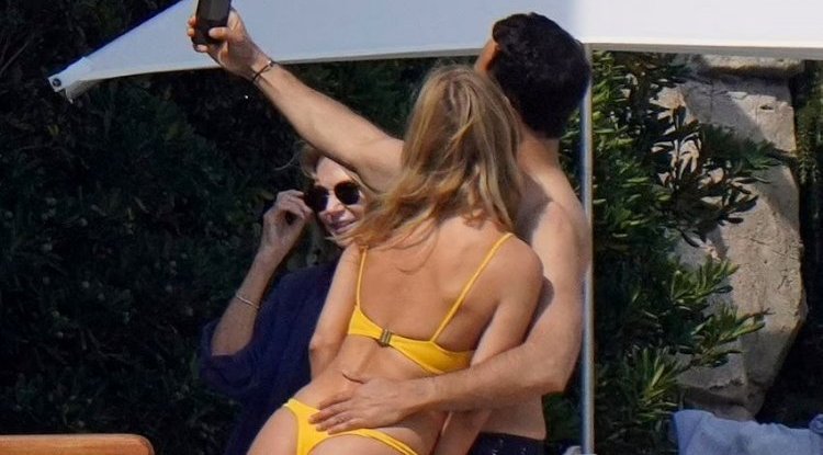 She crawled into a thong to hang out with a mysterious man, then surprised everyone in a dress on the red carpet!