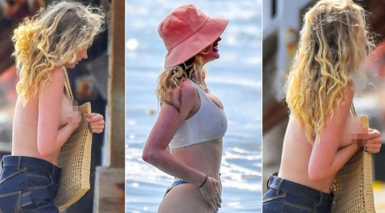 She covered herself with a towel on the beach