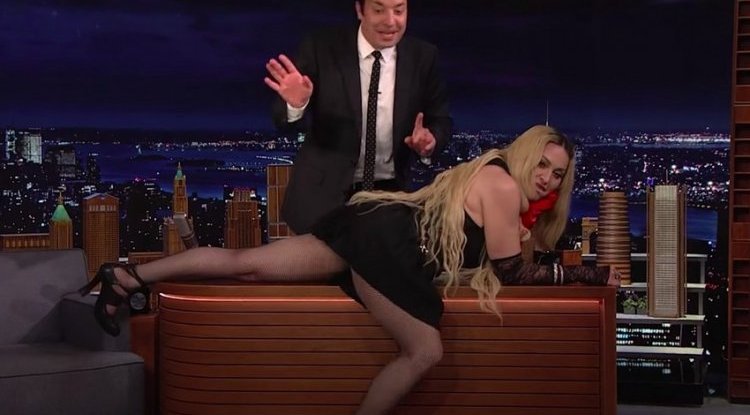 At the age of 64, Madonna flashes the audience and crawled on the table on 'The Tonight Show'