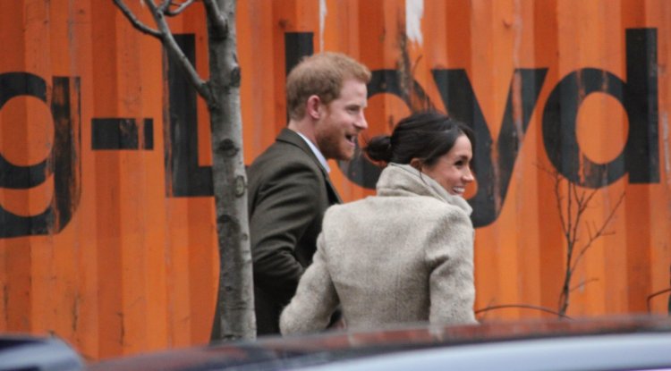 Harry and Meghan share a rare public kiss